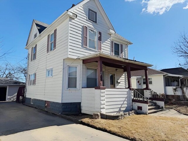 609 Baltimore St, Waterloo, IA 50702 - view of front of home with an outbuilding, covered porch, and a garage