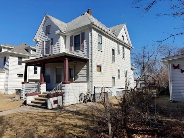 609 Baltimore St, Waterloo, IA 50702 - view of front of property with covered porch and a chimney