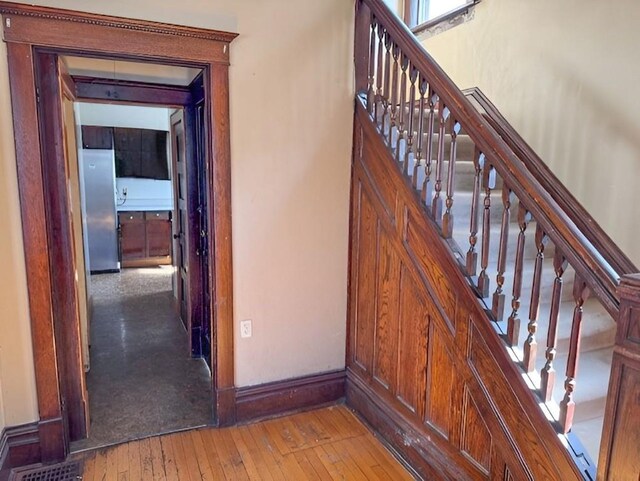 609 Baltimore St, Waterloo, IA 50702 - staircase with visible vents, baseboards, and hardwood / wood-style floors