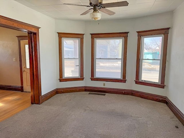 609 Baltimore St, Waterloo, IA 50702 - spare room with visible vents, a ceiling fan, baseboards, and carpet floors