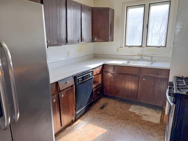 609 Baltimore St, Waterloo, IA 50702 - kitchen featuring tile patterned floors, stainless steel appliances, light countertops, and a sink