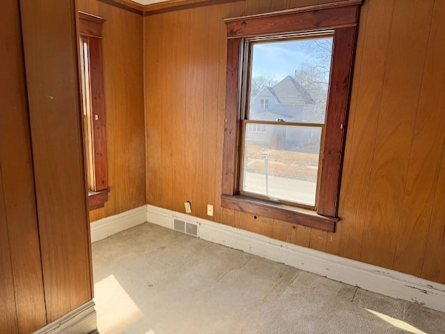 609 Baltimore St, Waterloo, IA 50702 - empty room with visible vents, baseboards, and wooden walls