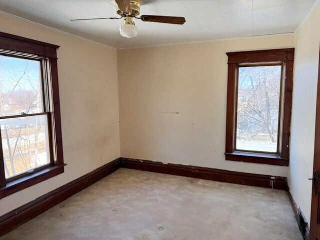 609 Baltimore St, Waterloo, IA 50702 - carpeted spare room featuring ornamental molding, baseboards, and ceiling fan