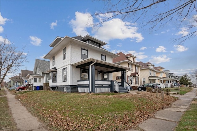 view of home's exterior featuring a residential view, a lawn, and covered porch