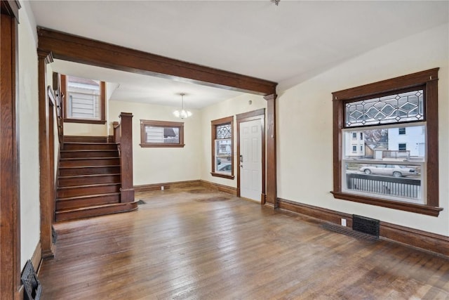 interior space with stairway, a healthy amount of sunlight, baseboards, and wood-type flooring