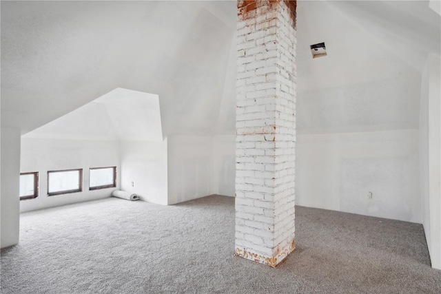 additional living space featuring lofted ceiling and carpet