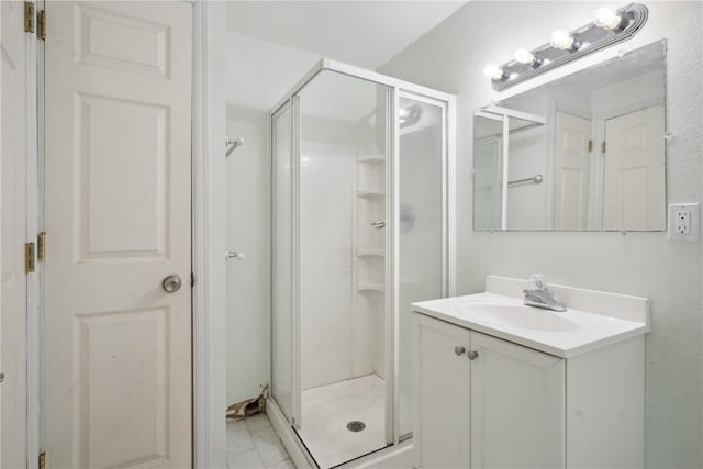 bathroom featuring a stall shower and vanity