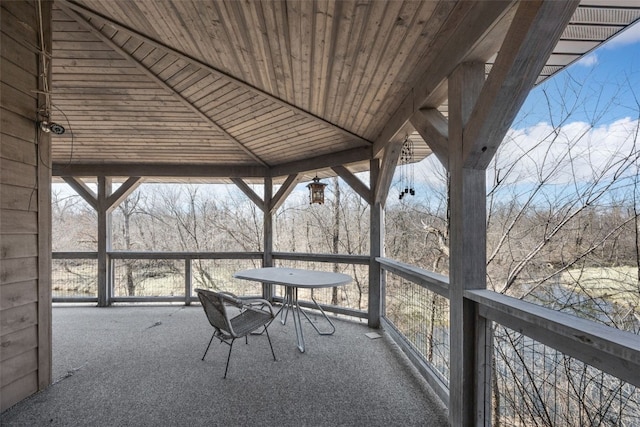 unfurnished sunroom featuring wood ceiling and vaulted ceiling