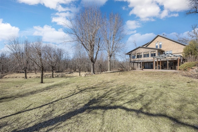 view of yard with a wooden deck and a patio area