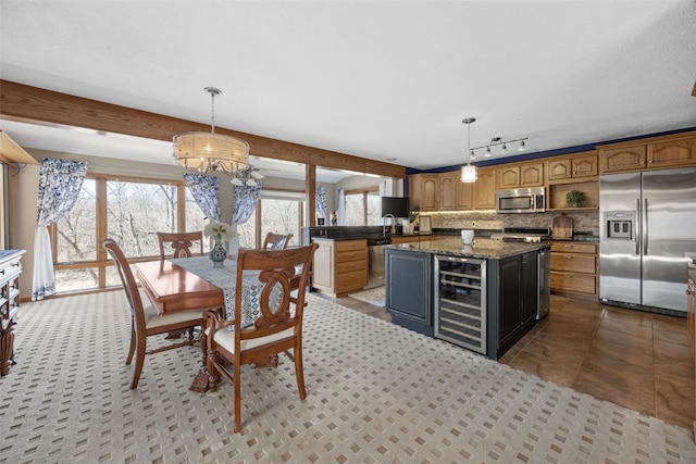 dining room featuring beam ceiling, beverage cooler, and a chandelier