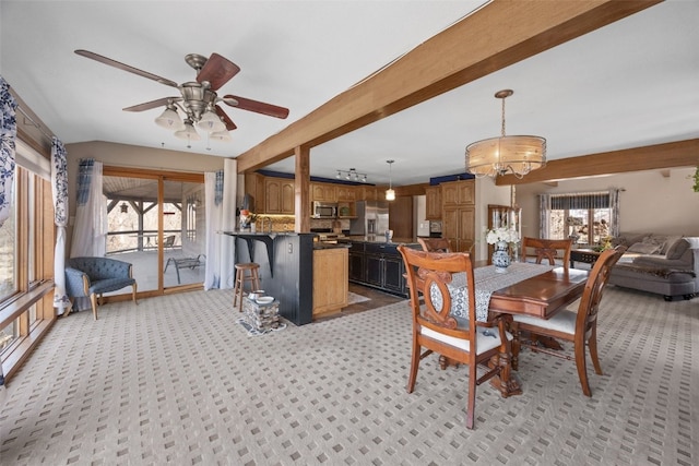 dining area featuring beamed ceiling and ceiling fan