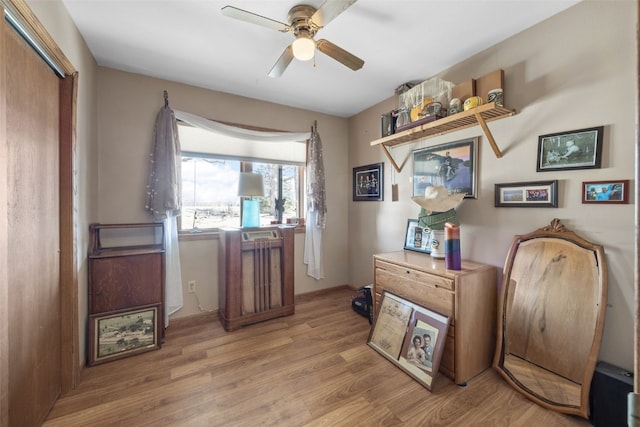 interior space with light wood-style floors and a ceiling fan