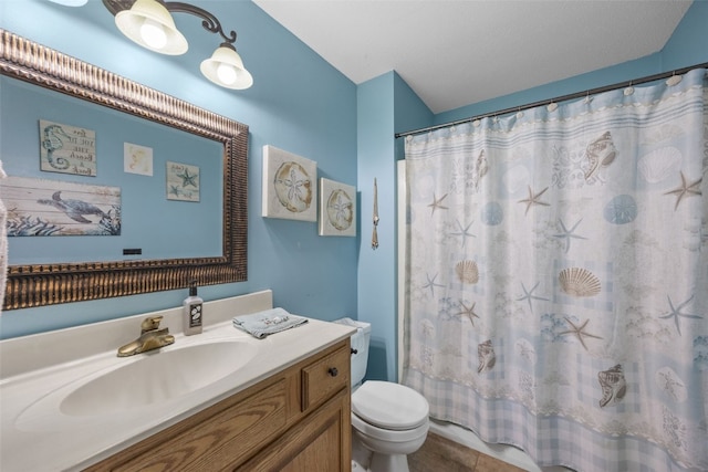 bathroom featuring a shower with shower curtain, toilet, and vanity