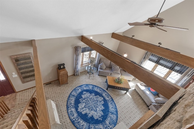 living area featuring ceiling fan and vaulted ceiling