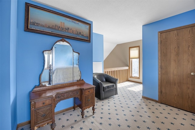 living area featuring baseboards, carpet, and vaulted ceiling