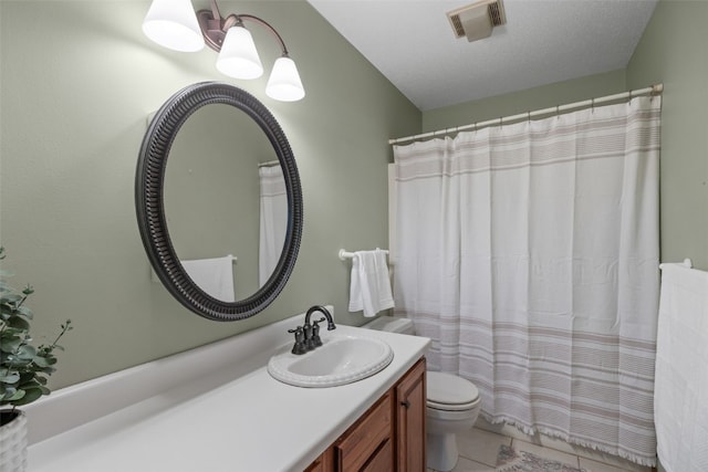 full bathroom with vanity, visible vents, tile patterned flooring, a textured ceiling, and toilet