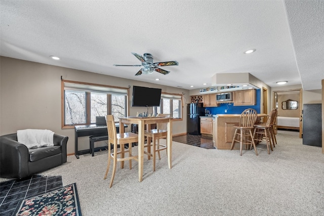 dining room with a textured ceiling, recessed lighting, baseboards, and light carpet