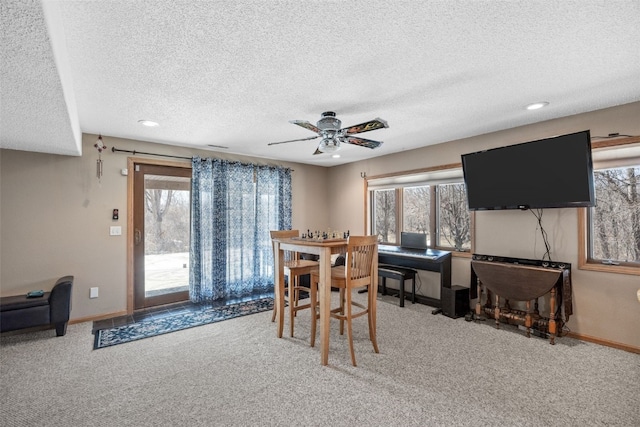 carpeted dining space featuring recessed lighting, baseboards, a textured ceiling, and ceiling fan