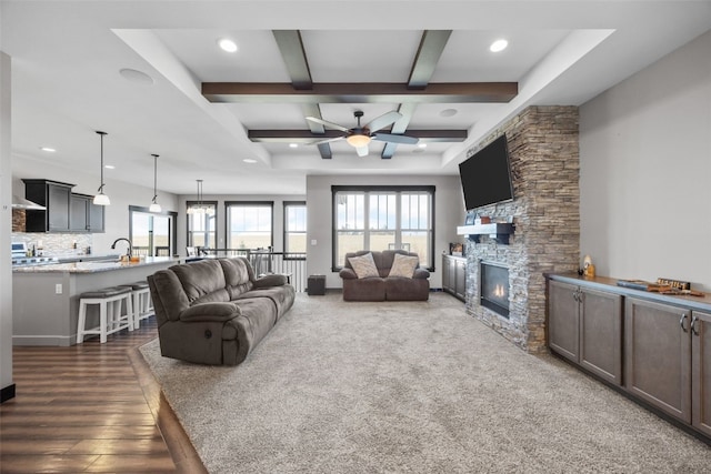 living room with beam ceiling, recessed lighting, a fireplace, and dark wood-type flooring