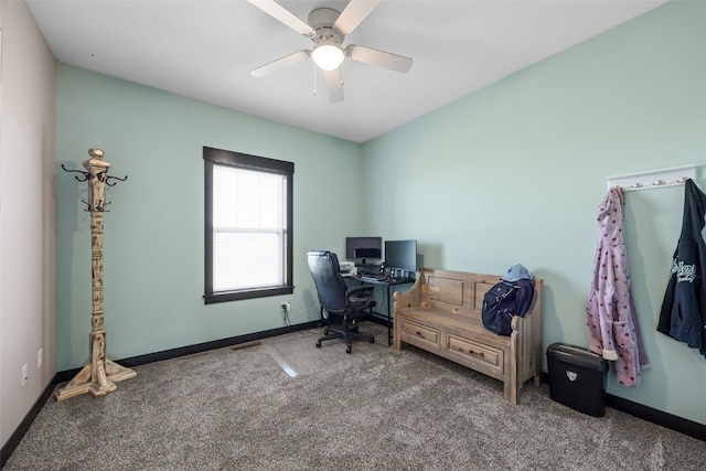 carpeted home office featuring baseboards and a ceiling fan