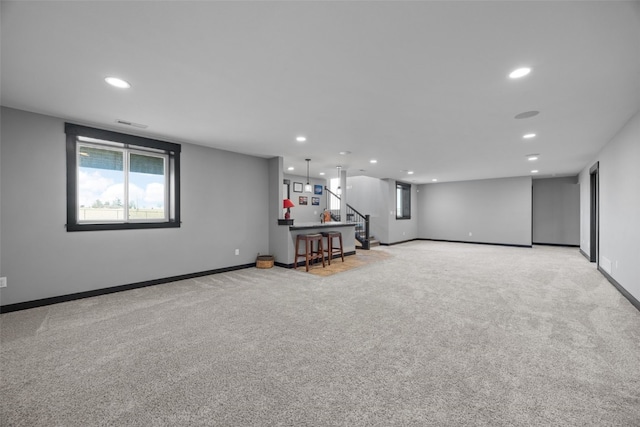 below grade area with recessed lighting, baseboards, and light carpet