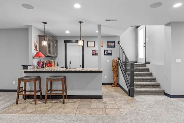 kitchen with recessed lighting, glass insert cabinets, a peninsula, and hanging light fixtures