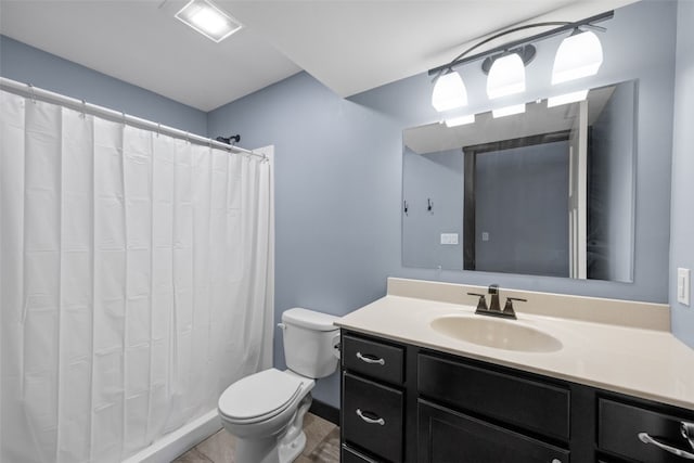 bathroom with toilet, vanity, and a shower with curtain