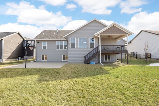 back of property with stairway, fence, ceiling fan, a patio area, and a lawn