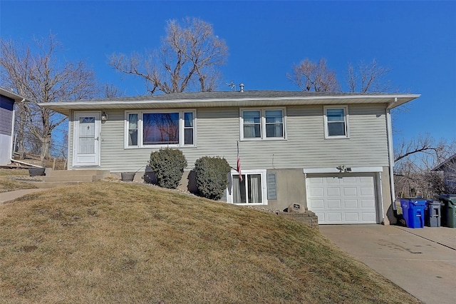 view of front of home with an attached garage, concrete driveway, and a front lawn