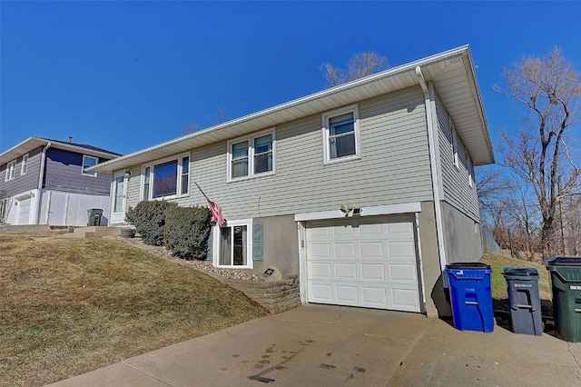 view of front of property featuring concrete driveway and a garage