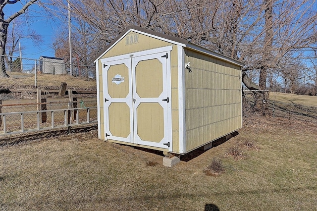 view of shed with fence