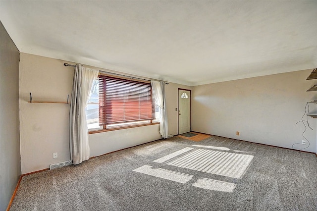 carpeted empty room featuring visible vents