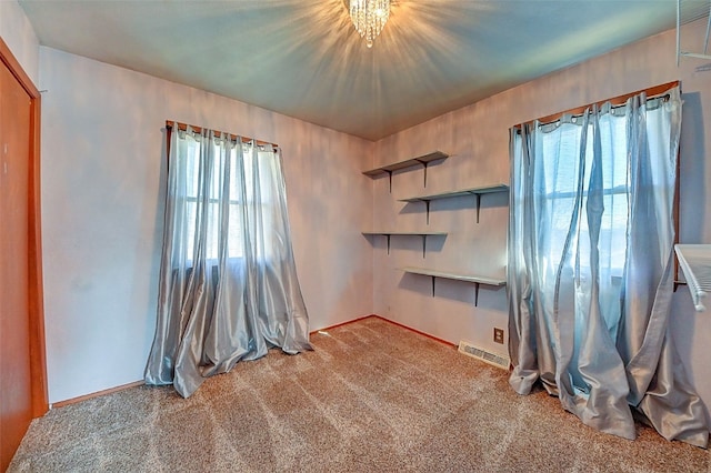 unfurnished bedroom featuring carpet and visible vents