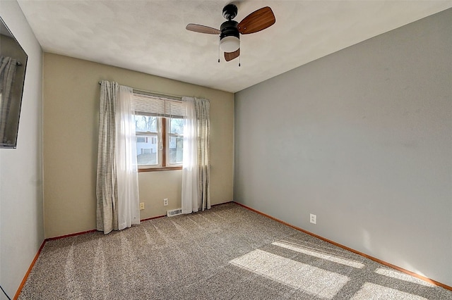 empty room with visible vents, carpet, and baseboards