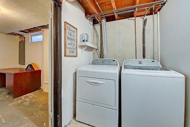 washroom featuring electric panel, separate washer and dryer, and laundry area