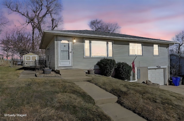 view of front of house featuring a lawn and a garage