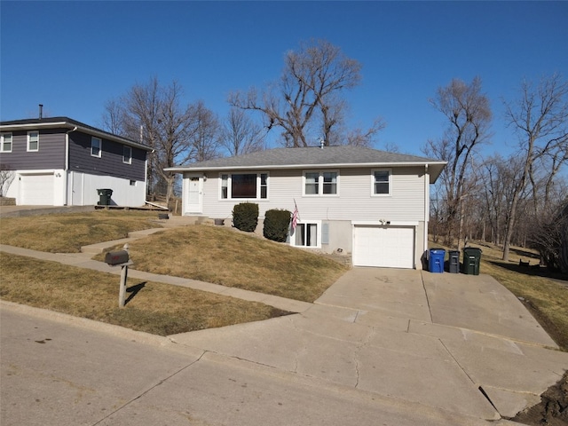 view of front of house with a garage, a front lawn, and driveway