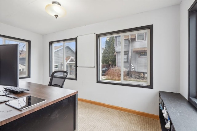 office area with baseboards and light carpet