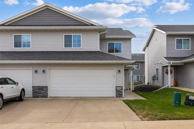 view of front of house featuring stone siding, an attached garage, concrete driveway, and a front lawn