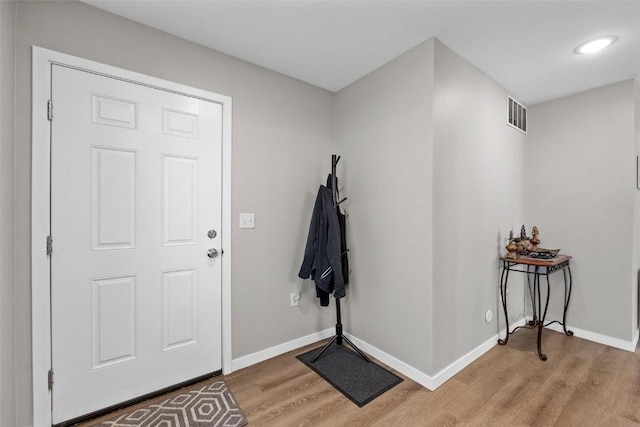 foyer with visible vents, baseboards, and light wood-style floors