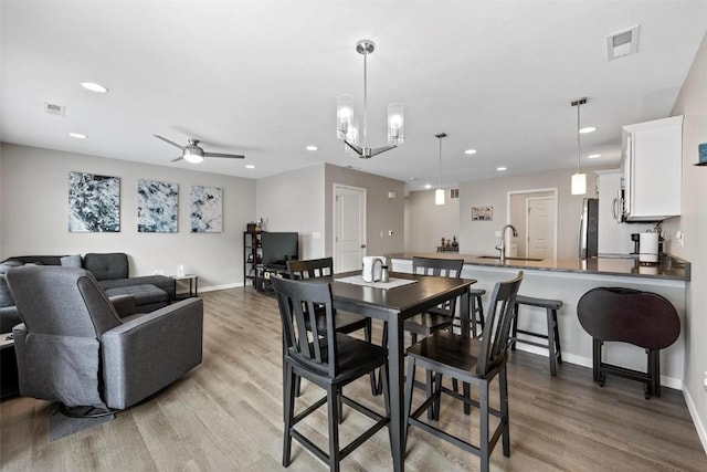 dining area featuring recessed lighting, visible vents, and light wood-style floors