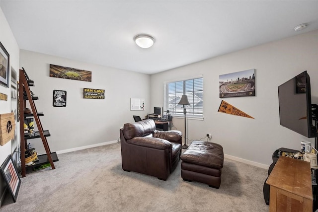 living area with baseboards and light carpet