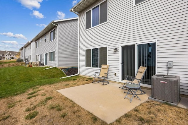 back of house featuring a yard, a patio, and central AC