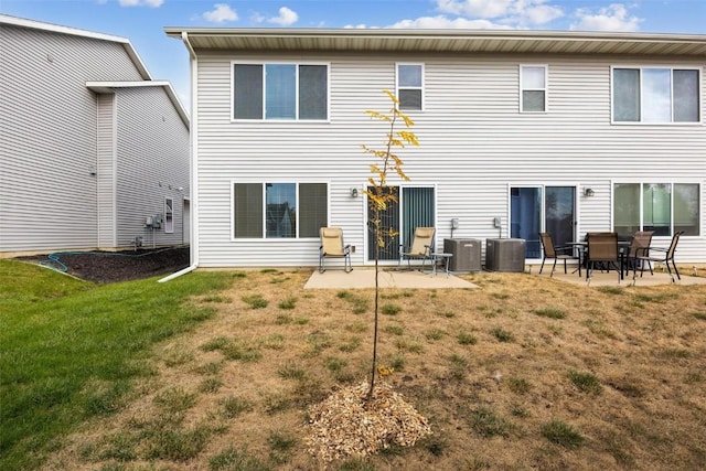 back of property with a yard and a patio area