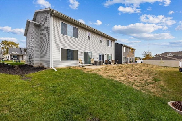 back of property with a patio and a lawn