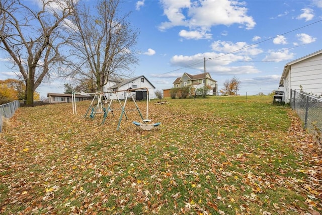 view of yard with a playground and a fenced backyard