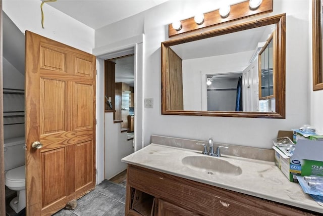 bathroom featuring tile patterned floors, toilet, and vanity