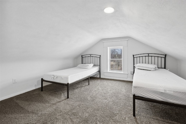 bedroom with lofted ceiling, carpet, and baseboards