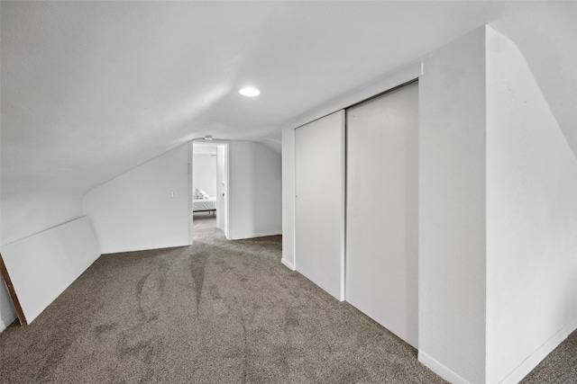 bonus room featuring carpet floors and vaulted ceiling