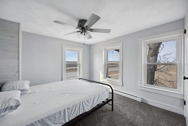 bedroom featuring a ceiling fan, carpet, baseboards, and a baseboard radiator